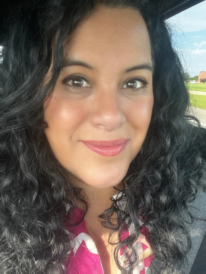 Karina, founder of Prolingua Spanish Language Institute — a warm, smiling woman with curly dark hair